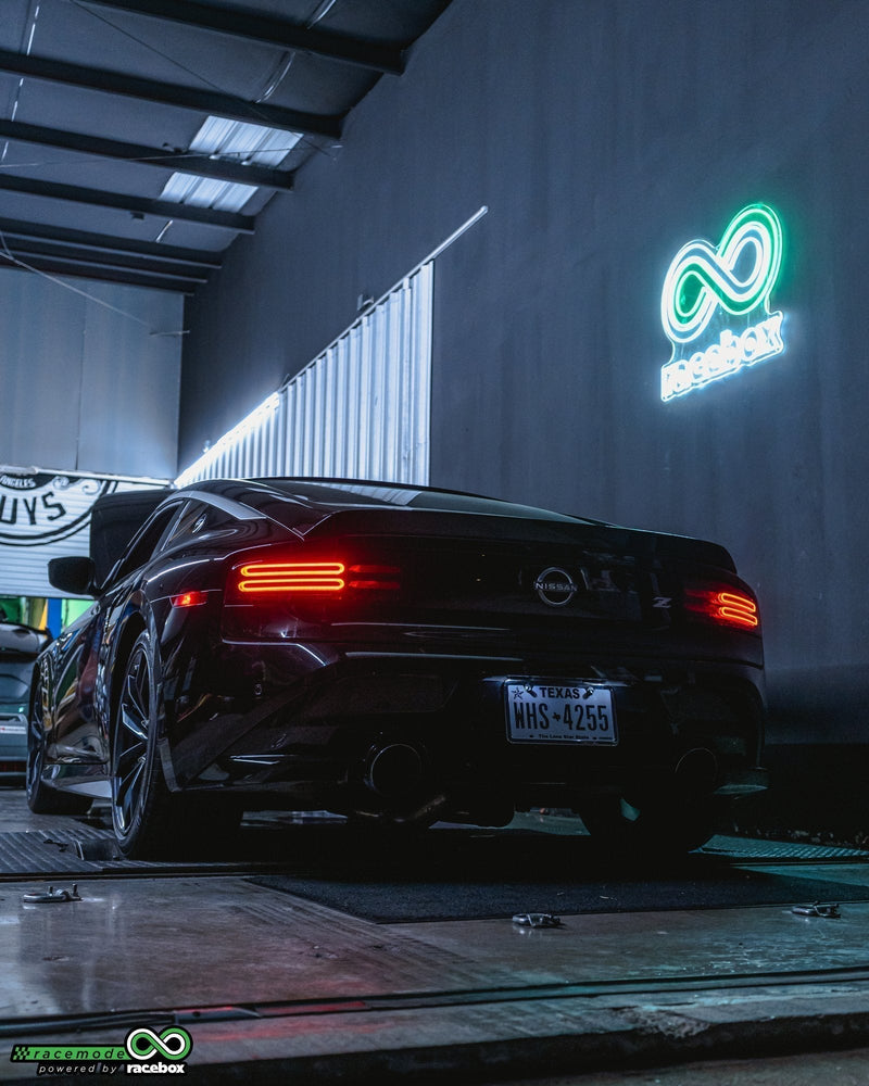 Nissan Z strapped to the Racebox DynoJet 224x dyno, rear three-quarter view in the dyno bay